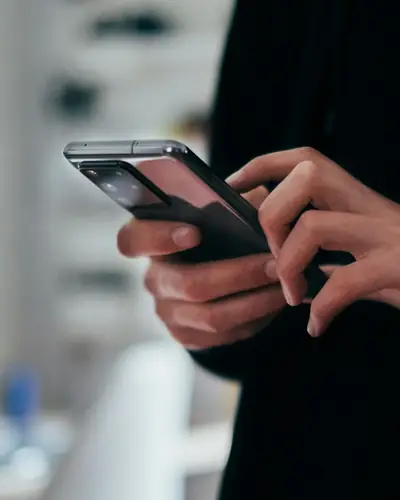Person holding a smartphone to back up chats