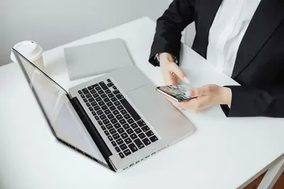 Smartphone next to a laptop on a desk for using Zangi on PC
